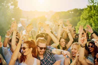 big group of people dancing, drinking and enjoying the party at sunny day