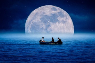a young man, a young woman, paddling in the sea at night, with the moon falling beautifully.