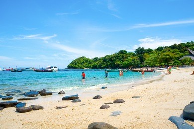 banana beach on coral (ko he) island on a sunny day, phuket, thailand 