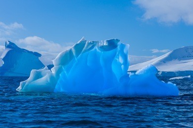 blue in blue. wonderful transparent iceberg in antarctica