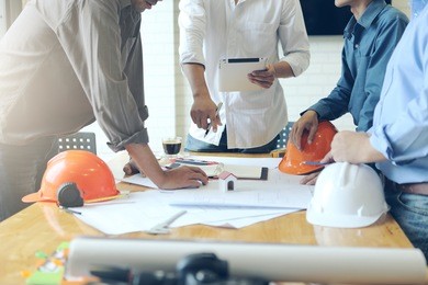 business objects of team engineers office with construction engineer architect and worker looking building model 