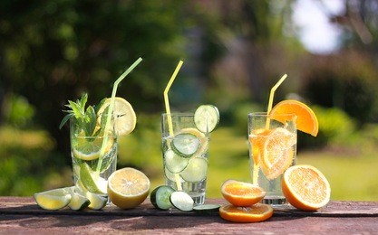 healthy detox water with fruits: lemon, lime, orange, mint. summer holidays, travel, vacation concept.