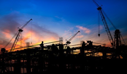 silhouette of the construction site on sunset background