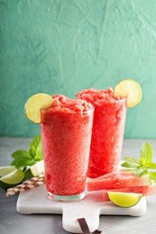 watermelon slushie with lime, summer refreshing drink in tall glasses