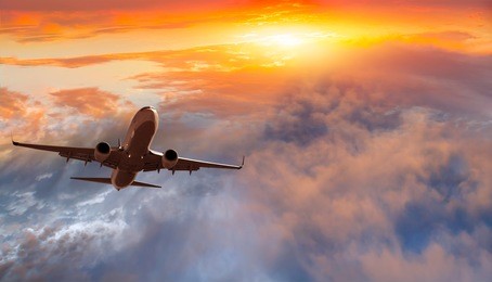 airplane in the sky at sunset