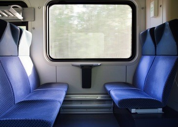 photo of five blue seats facing each other in modern european train