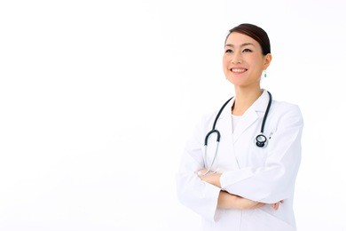 female doctor smiling - isolated over a white background