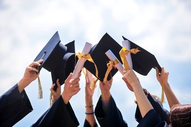 graduation caps thrown in the air       