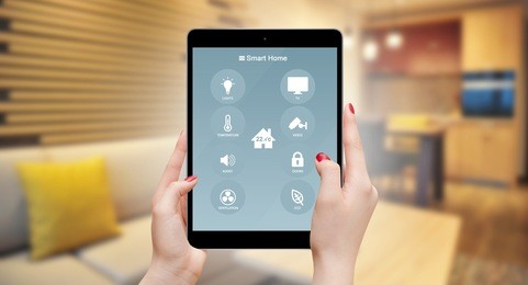 girl using tablet with home remote control , living room in background