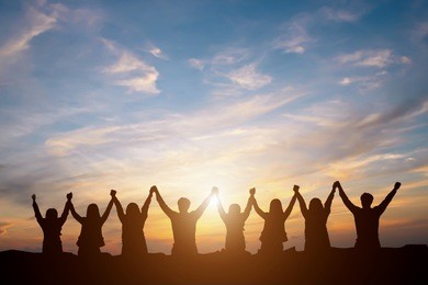 silhouette of happy business human team making high hands over head in sunset sky evening time background for business teamwork concept and freedom 