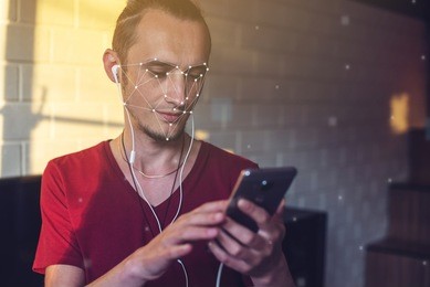 biometric verification. modern young man with the phone. the concept of a new technology of face recognition on polygonal grid is constructed by the points of it security and protection
