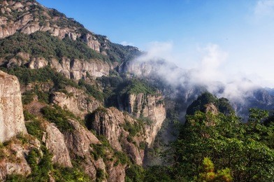 early morning clouds hanging over yandangshan or yandang mountains in china in zhejiang province.