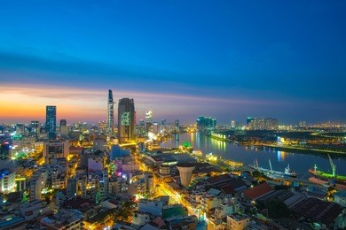 downtown saigon, ho chi minh city riverside in night - the biggest city in vietnam