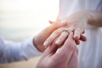 putting ring on hand with sunset