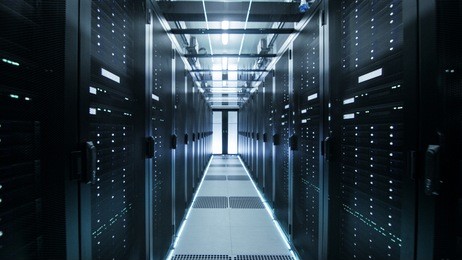 shot of corridor in working data center full of rack servers and supercomputers.