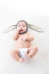 smiling cute asian baby isolated on white,baby wearing wool rabbit hat