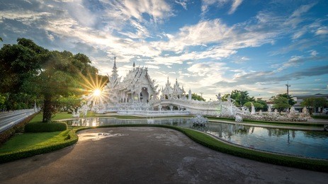 wat rong khun or white temple in chiang rai, thailand in sunset time with a beautiful sky.