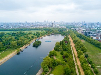 aerial hyde park view in london with a pond by the city.
