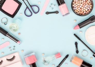 set of professional decorative cosmetics, makeup tools and accessory on blue background with copy space for your text. beauty, fashion, party and shopping concept. flat lay frame composition, top view
