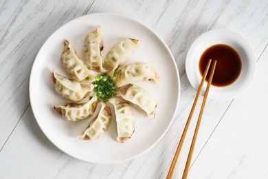 plate of japanese gyoza, dumplings snack , with soy sauce