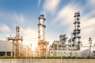 view of the oil and gas industry, refinery factory petrochemical plant showing main-station of pipelines and towers during sunny day 