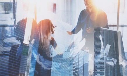 teamwork process.young team of businessmans making great business discussion in modern coworking office.double exposure,skyscraper building blurred background.horizontal.flares effect