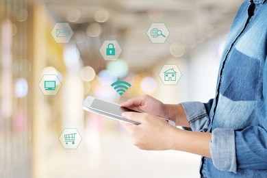 hand using tablet with internet of things icon on blurred background, business and technology concept