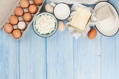 dairy products on wooden table. milk, cheese, egg, curd cheese and butter. top view with copy space