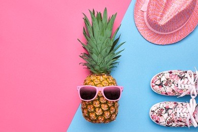 fashion pineapple. bright summer color. clothes accessories set. creative art concept. tropical fruit, stylish sunglasses. minimal. hot beach vibes. party mood on pink. flat lay.