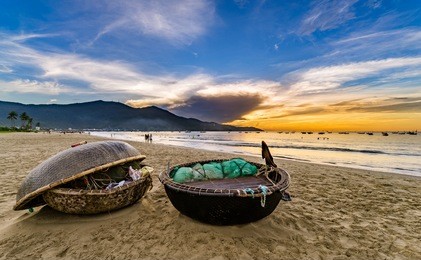 my khe beach is a beautiful beach in danang city ,  vietnam.  the sunrise is on creels , ( fishing boats in vietnam ).  my khe beach is in  top 6 beautiful beach in the world by forbes magazine.  