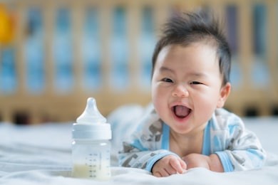 asian newborn baby smile with milk power bottle, baby, boy, mom, mother concept
