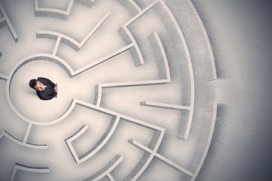 confused business man trapped in a circular maze