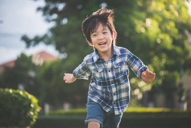 cute asian child playing pilot aviator in the park outdoors