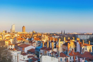 lyon, france. aerial view of the tiled rooftops and chimneys of the old town at sunset.