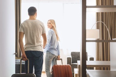 young couple travel together hotel room leisure