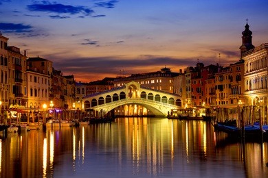 rialto bridge and grand canal at sunrise in venice, italy