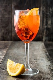 aperol spritz cocktail in glass on wooden table
