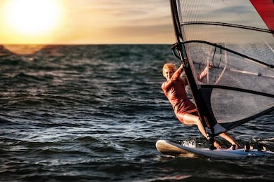 girl on windsurfing, fun in the ocean, extreme sport.
