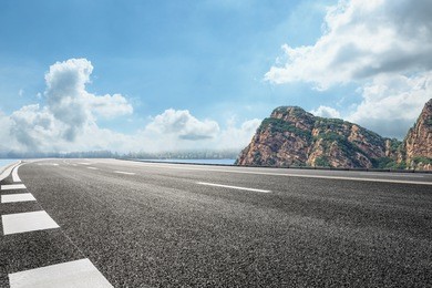 asphalt road and mountain under the blue sky