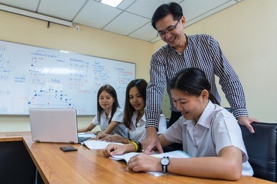 asian teacher giving lesson to group of college students in the classroom, university education concept