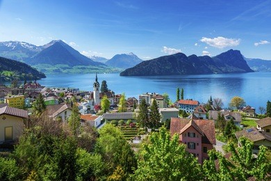 brienz town on lake brienz by interlaken, switzerland, with snow covered alps mountains in background