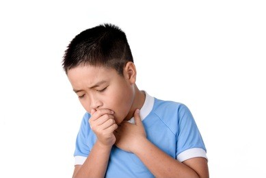 young asian thai boy has cough, isolated on white background.