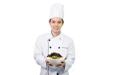 asian chef holding thai noodle (asian ramen) with eggs and mushroom and vegetable and tofu in a bowl, handsome asian man smiling , food concept , isolated on white background