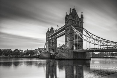 black and white photo of the tower bridge london, moving clouds tower bridge london 