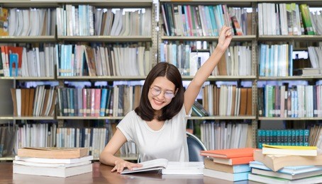 young student asian girl exam study with glasses complete,finish hard reading book homework and happy learning in classroom lesson education library knowledge center college high school university. 