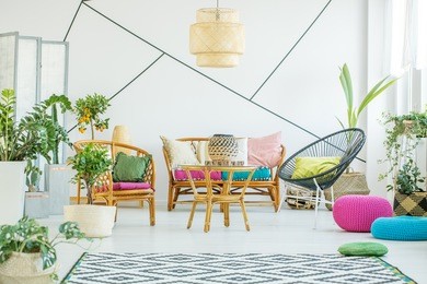 living room with colorful poufs, plants and decorative tape on the wall