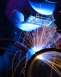 mig welder uses torch to make sparks during manufacture of metal equipment.