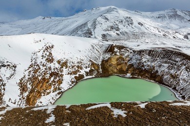 iceland highlands - askja crater lake. giant volcano askja offers a view at two crater lakes. the smaller, turquoise one is called viti and contains warm geothermal water and is good for swimming.