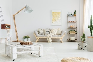 white blanket lying on bright wooden couch in a room