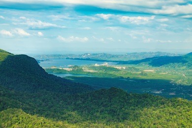 view of blue sky, sea and mountain seen from cable car viewpoint, langkawi, malaysia. picturesque landscape with tropical forest, beaches, small islands in waters of strait of malacca